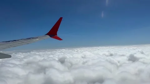 Though the window portal view over the wing of Aircraft air plane flying high al Stock Footage 230119419