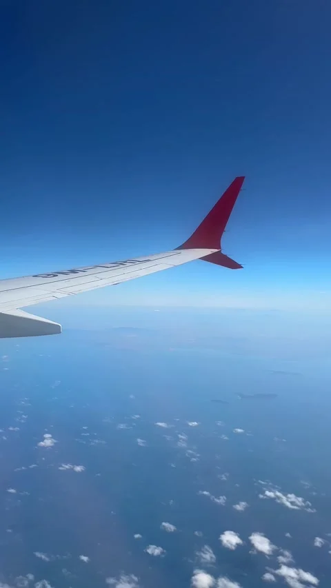 Though the window portal view over the wing of Aircraft air plane flying high al Stock Footage 230119430