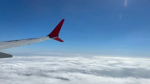 Though the window portal view over the wing of Aircraft air plane flying high al Stock Footage 230119435