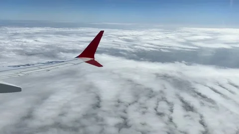 Though the window portal view over the wing of Aircraft air plane flying high al Stock-Footage 230119443