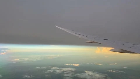 Though the window view over the wing of Aircraft air plane flying high altitude  Stock Footage 230119402