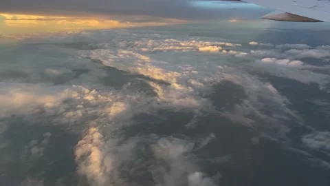 Though the window view over the wing of Aircraft air plane flying high altitude  Stock Footage 230119403