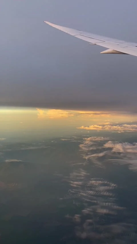 Though the window view over the wing of Aircraft air plane flying high altitude  Stock Footage 230119404