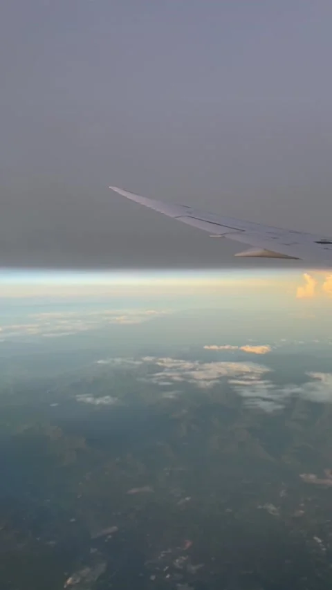 Though the window view over the wing of Aircraft air plane flying high altitude  Stock Footage 230119409