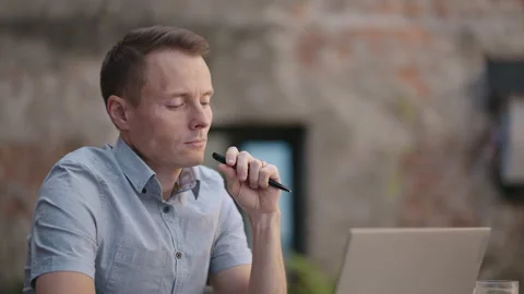 Thoughtful 30s man thinking of problem solution working on laptop. Serious Stock Footage 159594521