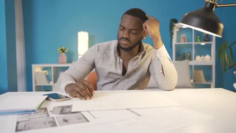 Thoughtful african man working on project. Stock Footage 228804651