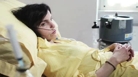 Thoughtful and depressed woman in a hospital bed for a serious illness Stock Footage