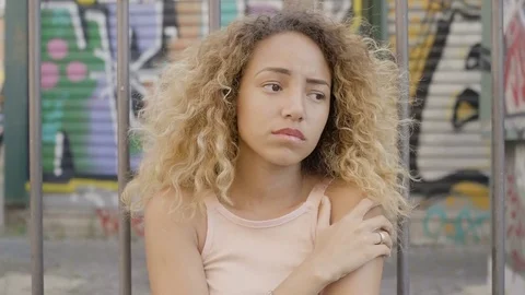 Thoughtful and sad lonely young woman on the outskirts near a market Stock Footage