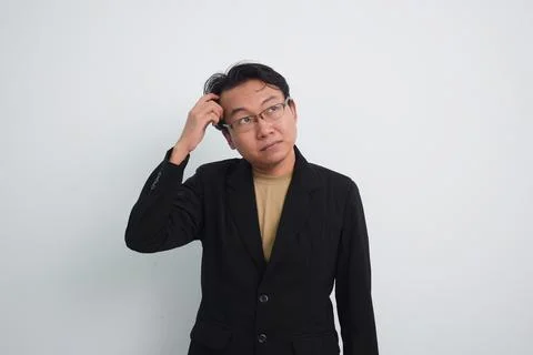 Thoughtful asian businessman with currious face think about solution in isolated Foto stock