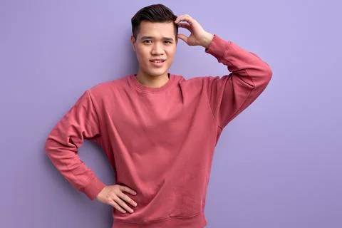Thoughtful asian guy try to remember, holding hands on head Stock Photos