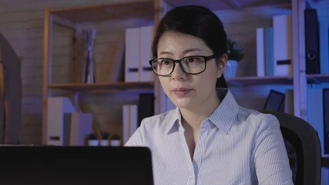 Thoughtful asian lady hard working in midnight Stock Footage 100950284