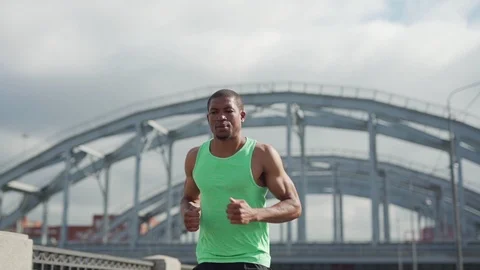 Thoughtful athlete running down bridge Video stock 117064745