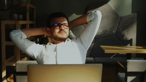 Thoughtful bearded freelancer in the loft cafe looking to the sun rays Stock Footage 112995486