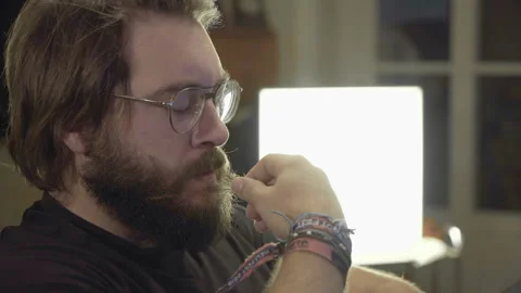 Thoughtful Beardy Man on PC Video stock 143186935