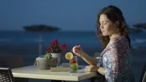 Thoughtful beautiful lady in love missing or waiting for someone at beach cafe Stock Footage 67477785
