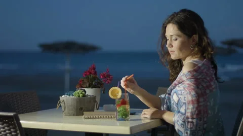 Thoughtful beautiful lady in love missing or waiting for someone at beach cafe Stock Footage 67485588