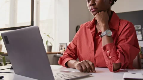 Thoughtful Black Female Programmer Typing on Laptop in Office Stock-Footage 336708328