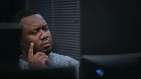 Thoughtful Black Male Programmer Concentrating on Work at Computer Stock Footage 324025238