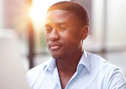 Thoughtful black man in eyeglasses stack with hard task, looking at computer Foto stock