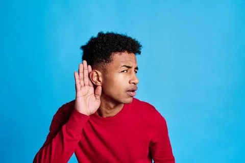 Thoughtful black man touching forehead and listening carefully Stock Photos