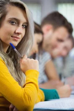 Thoughtful blonde student looking at camera Fotos Stock