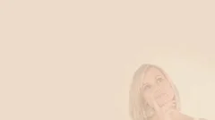 Thoughtful blonde woman imagining copy spaces Stock After Effects