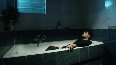 Thoughtful boy in the bathtub with clothes Stock Footage 170048190