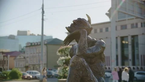 Thoughtful brass devil with horn statue on large city street Video stock 219471633