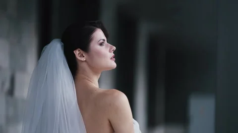Thoughtful bride in white veil posing in corridor Stock Footage 344703600