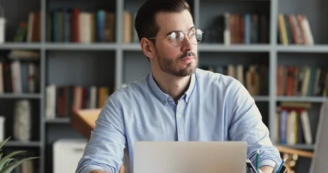 Thoughtful business man thinking of problem solution working on laptop Stock Footage 125977149