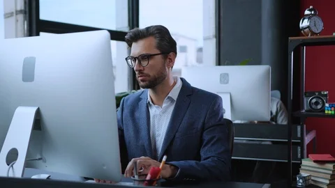 Thoughtful business manager working on project at table computer thinking over Video stock 119387877