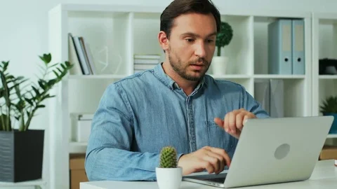 Thoughtful business young man working hard on the report in the laptop in the Stock Footage 77150858