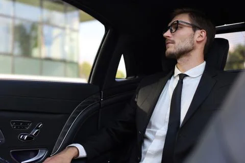 Thoughtful businessman looking away while sitting in the car. Stock Photos