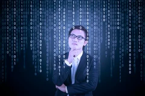Thoughtful businessman looking at binary code Foto stock