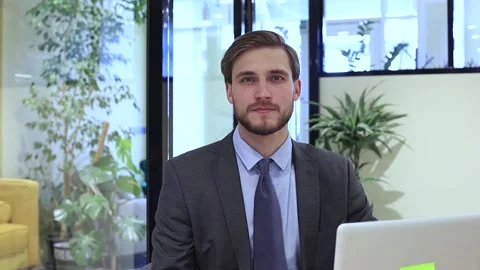 Thoughtful businessman solving business problems making notes working on laptop. Stock Footage 131648448
