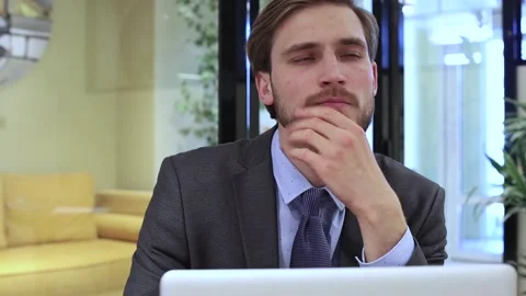 Thoughtful businessman solving business problems making notes working on laptop. Stock Footage 138292133