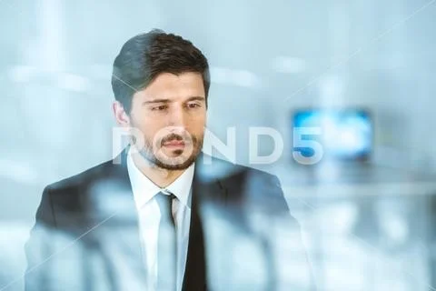 The thoughtful businessman stand near the window Stock Photos