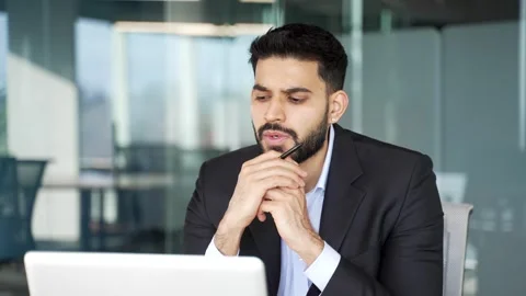 Thoughtful businessman thinking about problem solving while working on laptop  Stock Footage 334860514