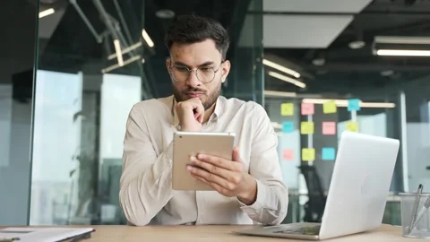 Thoughtful businessman is using digital tablet thinking about solving a problem  Stock Footage 319777093