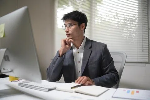 Thoughtful Businessman Working at Office Computer Stock Photos