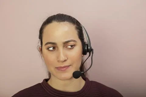 Thoughtful call center operator taking a cal Stock Photos