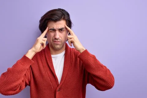 Thoughtful caucasian guy try to remember something, holding fingers on temple Stock Photos