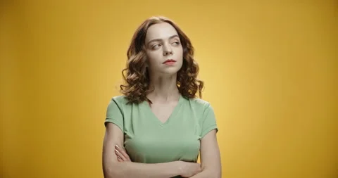 Thoughtful caucasian model holding back of her head while thinking about a Stock Footage 133360144