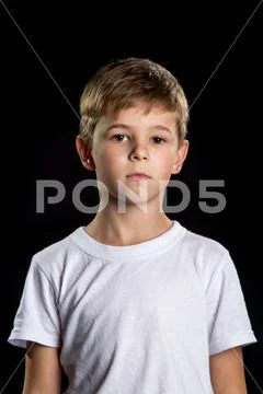 Thoughtful child portrait, intelligent boy on the black background looking Stock Photos