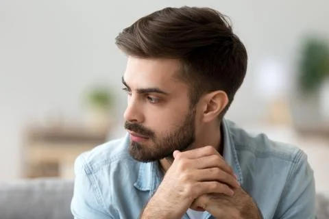 Thoughtful concerned man thinking about problem solution lost in thoughts Stock Photos