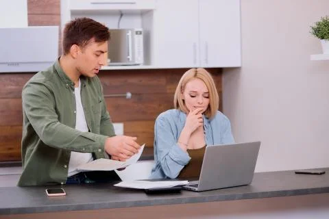 Thoughtful couple solving financial problems in family Fotos de archivo