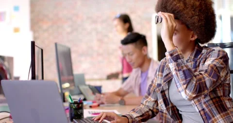 Thoughtful creative businesswoman working at computer in casual office, slow Stock Footage 340068372