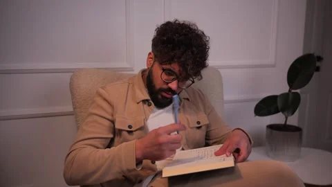 Thoughtful creative man writing ideas in journal Video stock 346989517