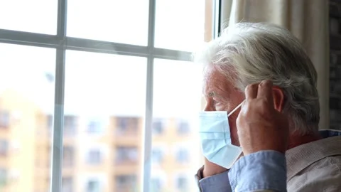 Thoughtful depressed old man looking out of window with hope, thinking over.. Stock-Footage 231622300