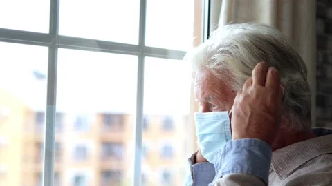 Thoughtful depressed old man looking out of window with hope, thinking over.. Stock Footage 231625510